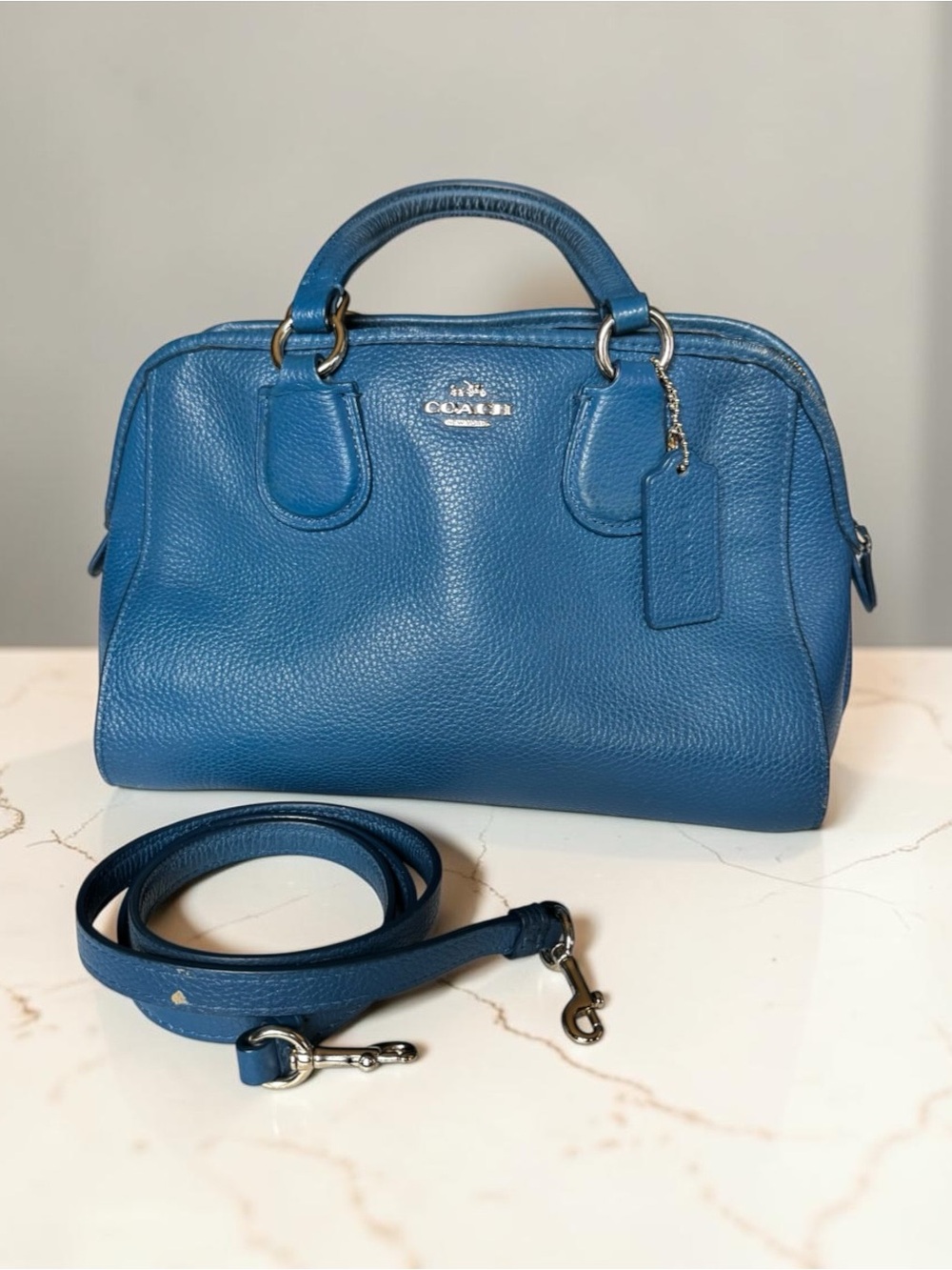 COACH pebbled leather satchel in rich blue. Dual top handles and a detachable cr
